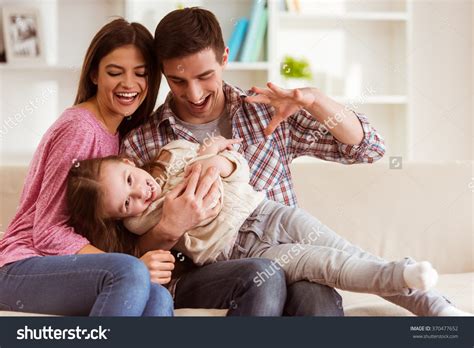 Stock Photo Smiling Young Parents And Their Child Are Very Happy They