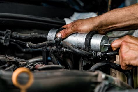Close Up Of Auto Mechanic Repairing Car Engine In Car Service Stock