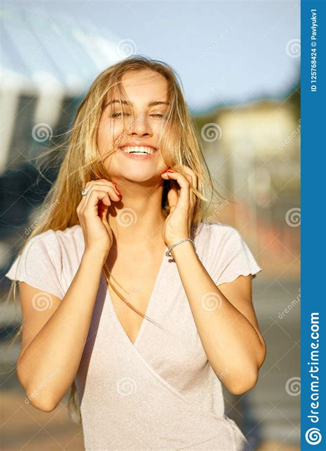 Cheerful Blonde Model With Long Hair Posing At The Background Of Stock