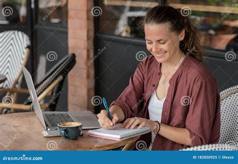 Happy Young Pretty Woman Using Laptop At Cafe Sitting In A Coffee Shop And Working On Computer