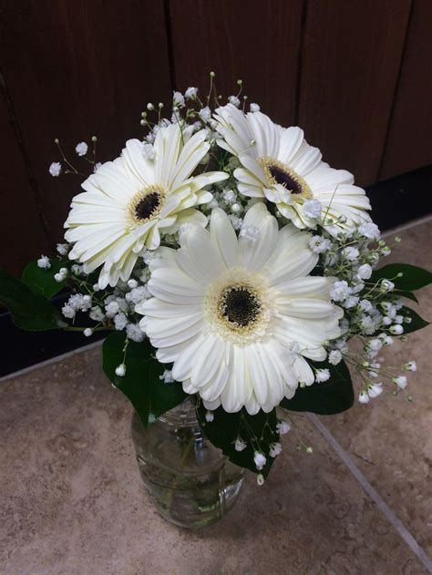 Chrysanthemums, roses, ranunculus, delphinium, marigolds White gerbera daisy bouquet with baby's breath and greens ...