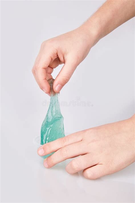 Kid S Hands Holding A Transparent Green Slime Isolated Stock Photo