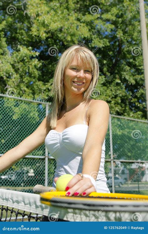 Woman Tennis Player With Racket And Ball Standing In Court Stock Image
