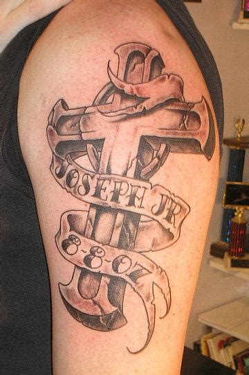 A tiny small ans simple cross tattoo design on middle finger. Cross Tattoo Designs
