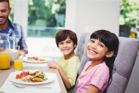 Smiling Children Sitting At Dining Table Stock Photo Image Of Dining