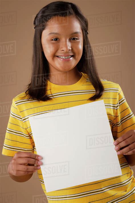 Studio Portrait Of Girl 10 11 Holding Blank Sheet Of Paper Stock