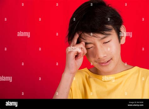 Portrait Of 13 Year Old Asian Boy Thinking Stock Photo Alamy
