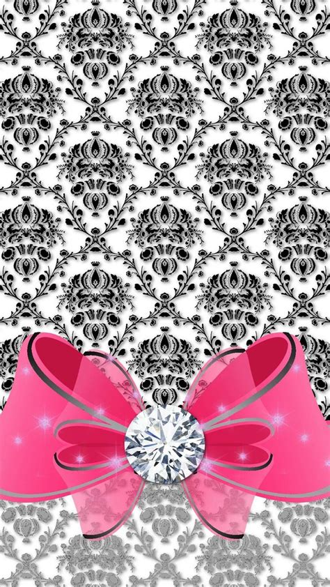 A Pink Bow With A Diamond In The Center On A Black And White Wallpaper