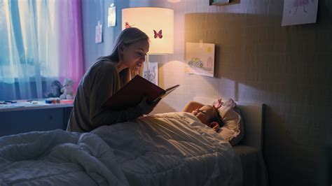 Young Loving Mother Reads Bedtime Stories To Her Little Beautiful