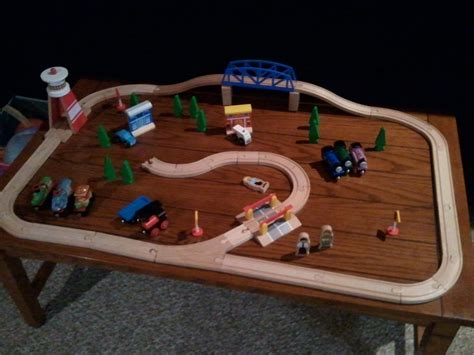 This coffee table layout includes backgrounds of mountains and buildings. {creative cents}: train {coffee} table!