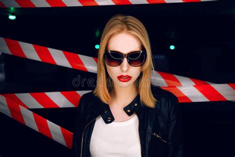 Portrait Of Blonde Girl With Red Lips Wearing A Rock Black Style On The