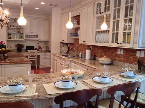 A Kitchen Filled With Lots Of Counter Top Space Next To A Dining Room