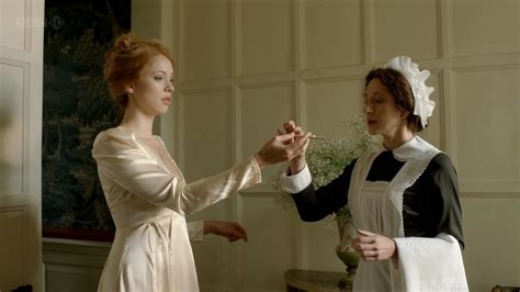 two women dressed in period clothing standing next to each other one holding the hand of