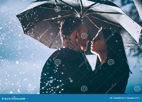 Young Couple Standing Under A Dark Umbrella Stock Photo Image Of Girl