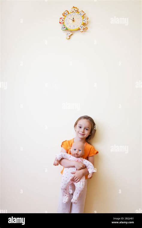 Little Girl Holding Doll Stock Photo Alamy