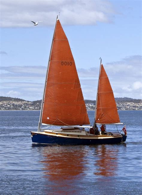 red sails sailboat sailing boat