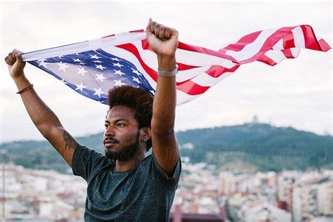 Young Black Man Waving An American Flag Outdoors By Stocksy