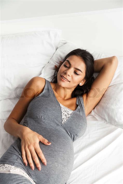 Pregnant Woman Indoors At Home Lies In Bed Stock Image Colourbox