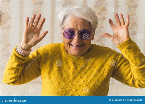 Funny Caucasian Grandmother In Purple Sunglasses Looking At Camera And