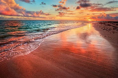 Amazingly Colorful Sea Beach Sunset With Reflective Red Sand Stock