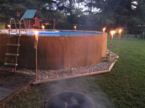 Reed Privacy Fence Added Around Our Above Ground Pool Accented With Tiki Torches And Landscaping