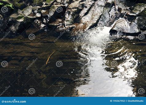 Mountain River Surrounded By Mountains A Waterfall Flowing Down From A