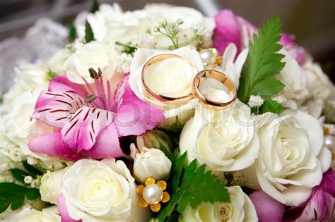 Wedding corsages are most often reserved for the mother of the bride, mother of the groom, grandmothers of the bride and groom, and other special. Gold wedding rings of the groom and the ... | Stock Photo ...