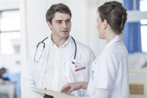 Doctor And Nurse Talking In Hospital Stock Photo
