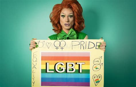 Drag Queen Celebrating Gay Pride Holding Banner With Rainbow Flag Stock