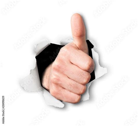 Hand Making Thumbs Up Sign Breaking Through A Thin Wall Or Paper Buy