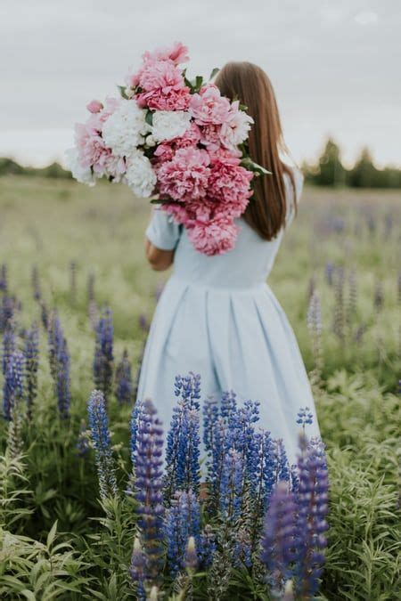 Woman Carrying Flowers Photo Free Person Image On Unsplash