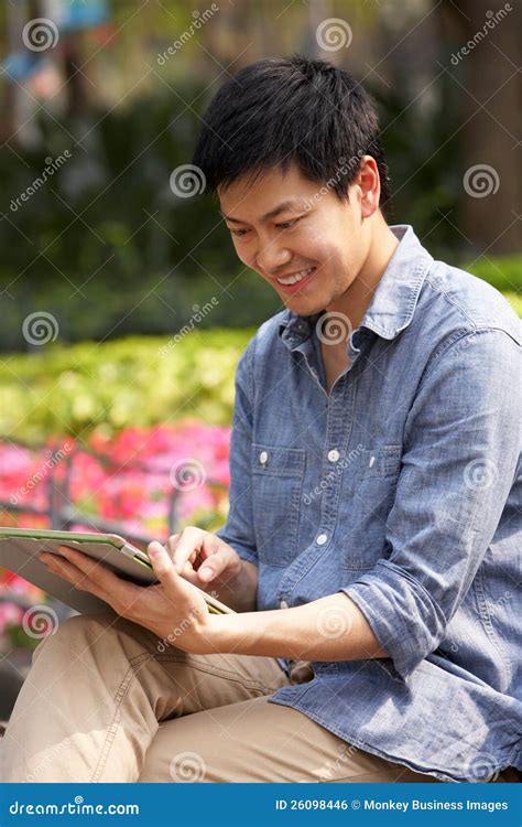 Young Chinese Man Using Digital Tablet Stock Photo Image Of Casual