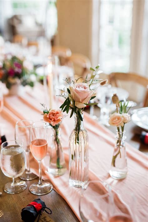 Bud vases down long tables at wedding, Simple and elegant centerpieces