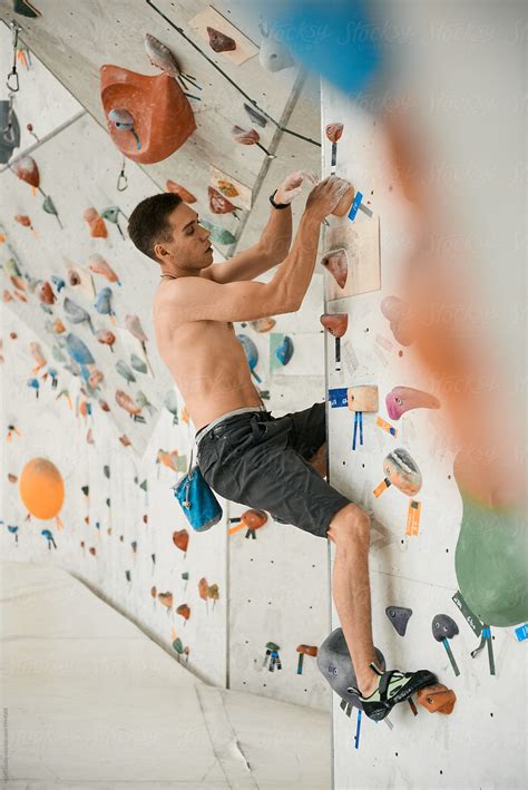Shirtless Man Climbing Wall In Gym Del Colaborador De Stocksy Milles