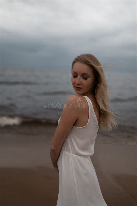 Close Up Portrait Of Beautiful Young Blonde Woman Beach Nymph In White Dress Near Sea With Waves