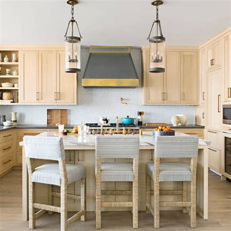 Rift white oak (rwo) is lighter in color than red oak, and different milling techniques accentuate the straight, vertical grain of the wood. Bleached white oak cabinets with blue tile, blue and woven barstools. Design by Joey Luke ...