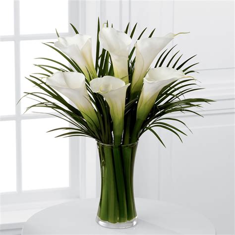 A Wonderfully Sophisticated Vase Of Calla Lilies Accompanied By Palm