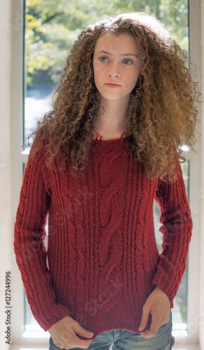 Curly Haired Teen In Red Sweater Buy This Stock Photo And Explore