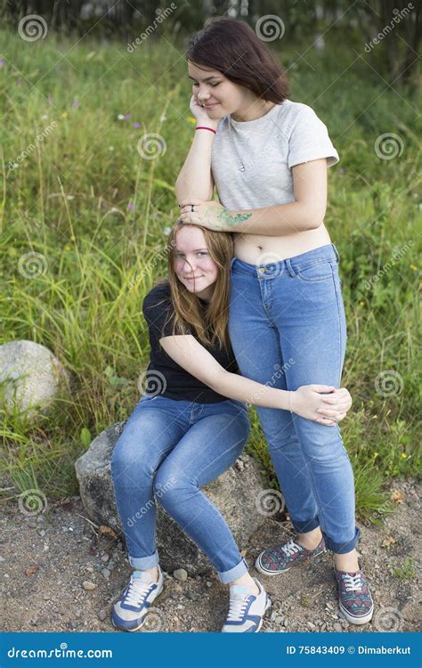 Two Teenage Girls Are Best Friends Hugging At The Glade Nature Stock