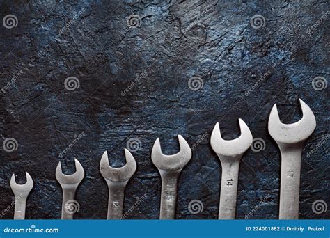 Set Of Wrenches On Background Of A Blue Concrete Wall Stock Photo