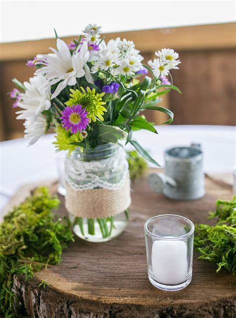 Daisy And Aster Centerpiece In Mason Jar On Wooden Slab