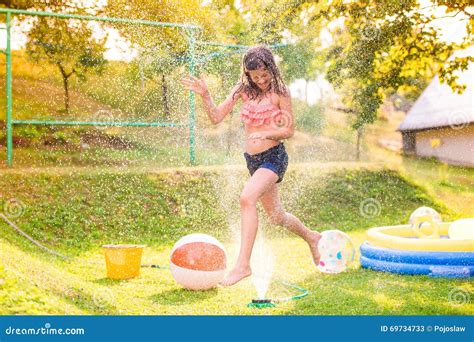 Girl Running Above A Sprinkler Sunny Summer Back Yard Stock Image Image Of Garden Splashing