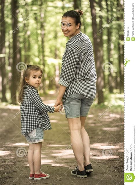 Mother And Young Daughter Walk In The Woods Stock Image Image Of