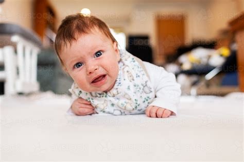 Image Of Two Month Old Baby Doing Tummy Time On White Mat With Copy