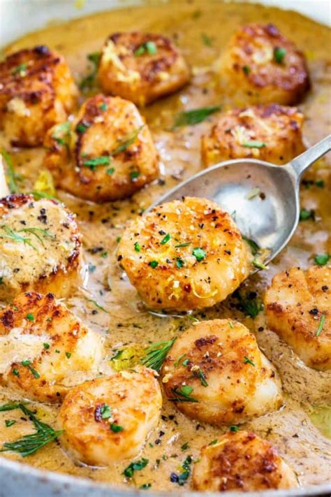 Seared Scallops With Lemon Garlic Sauce Cooking In A Pan