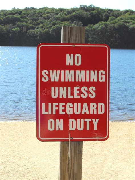 Beach Sign Warning No Swimming Unless Lifeguard On Duty Stock Photo