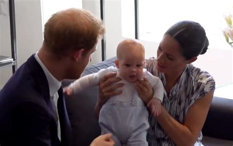 The card is a black and white portrait with baby archie in the front focus and his parents in the background. Meghan Markle and Prince Harry's Baby Archie Takes Center Stage in Family's 1st Christmas Card
