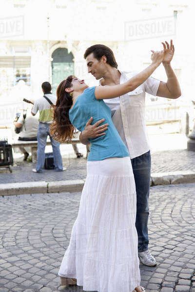 Caucasian Couple Dancing On City Street Stock Photo Dissolve