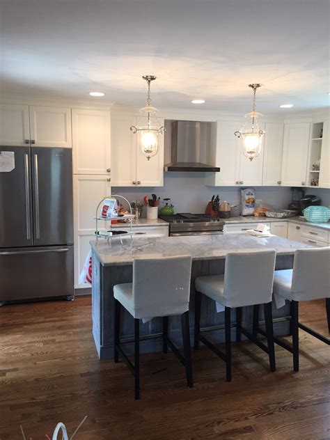 I am thinking of doing it with navy cabinets. Gray and white kitchen. Kitchen Island. Quartz Countertops ...