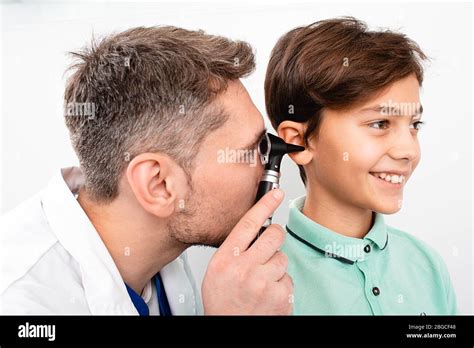 Pediatrician Examining Little Mixed Race Child With Otoscope Hearing